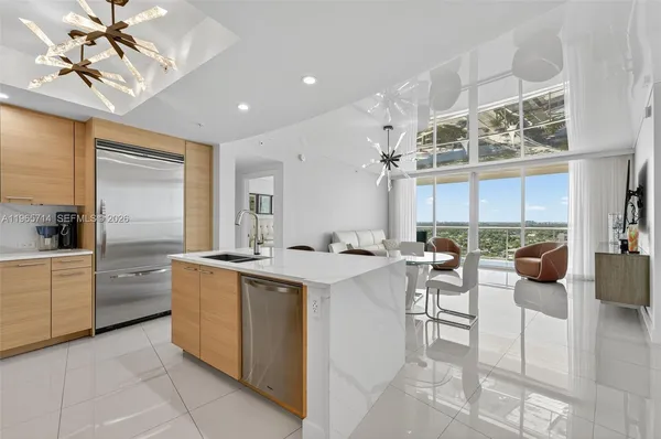 a kitchen with stainless steel appliances granite countertop a sink and a wooden cabinets with island