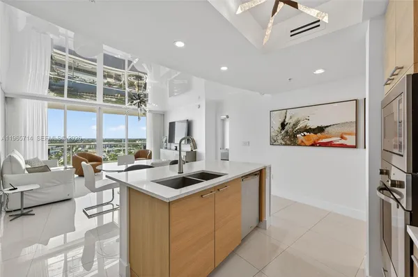 a living room with furniture a fireplace and a large window