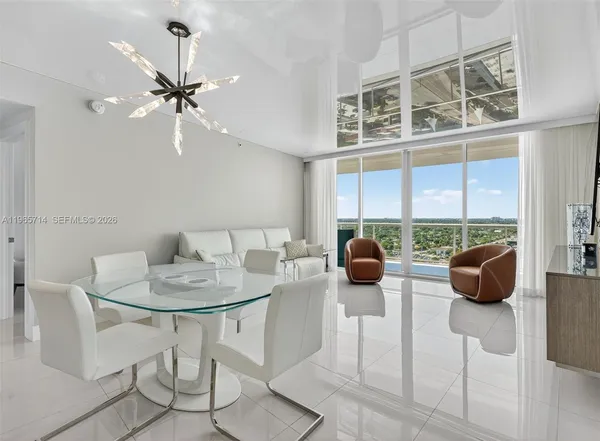 a bedroom with a bed a couch and a view of bedroom