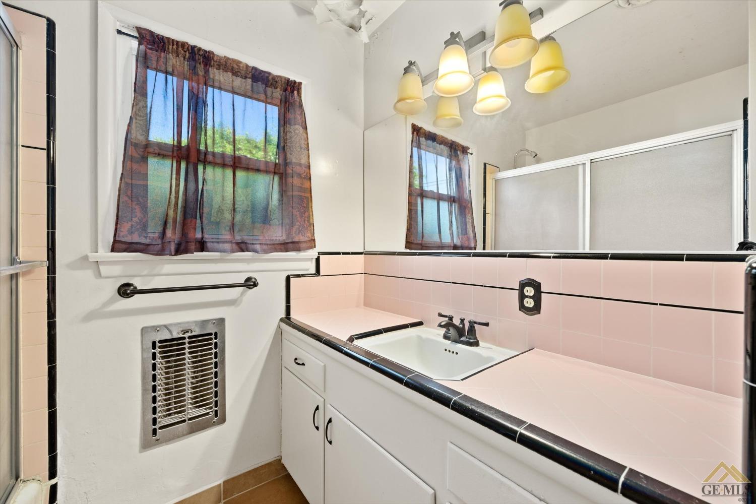 Undisclosed Address Wasco, CA 93280 - Photo 15 of 21 a bathroom with a sink and a mirror