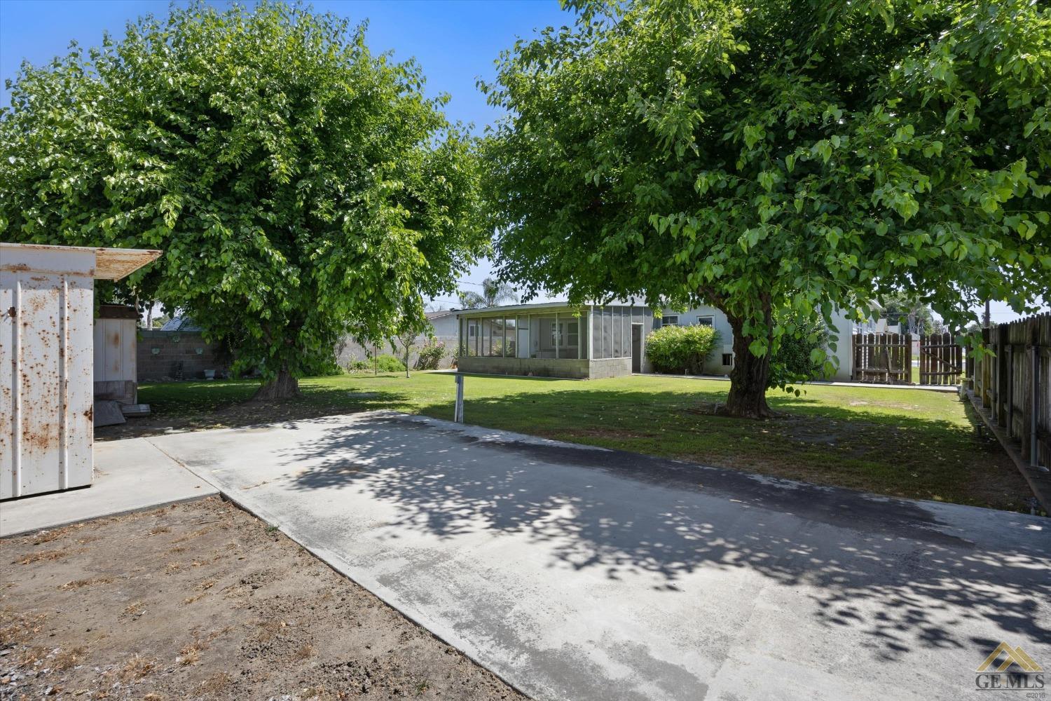 Undisclosed Address Wasco, CA 93280 - Photo 20 of 21 a front view of a house with a yard and tree