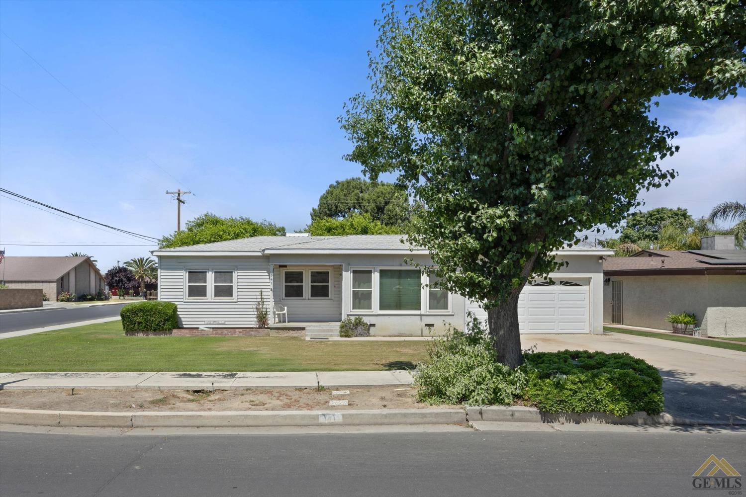 Undisclosed Address Wasco, CA 93280 - Photo 2 of 21 a front view of a house with a garden and plants