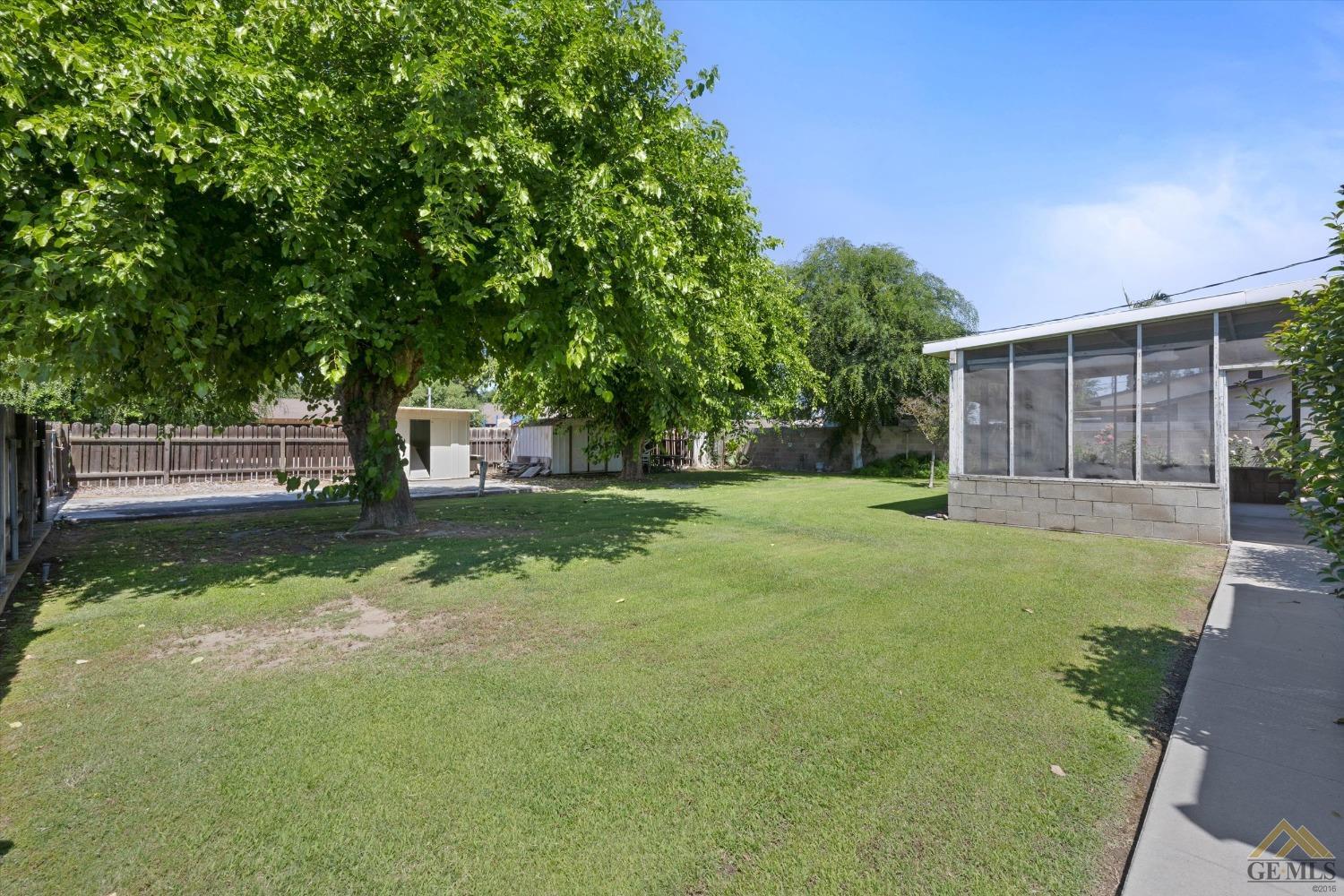 Undisclosed Address Wasco, CA 93280 - Photo 21 of 21 a view of a house with backyard and a tree