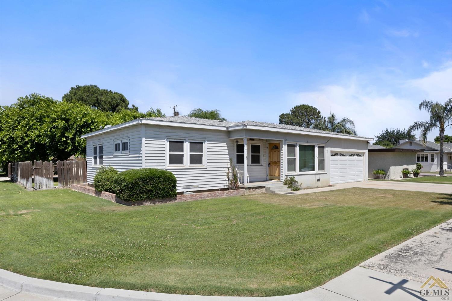 Undisclosed Address Wasco, CA 93280 - Photo 3 of 21 a front view of a house with a yard and porch