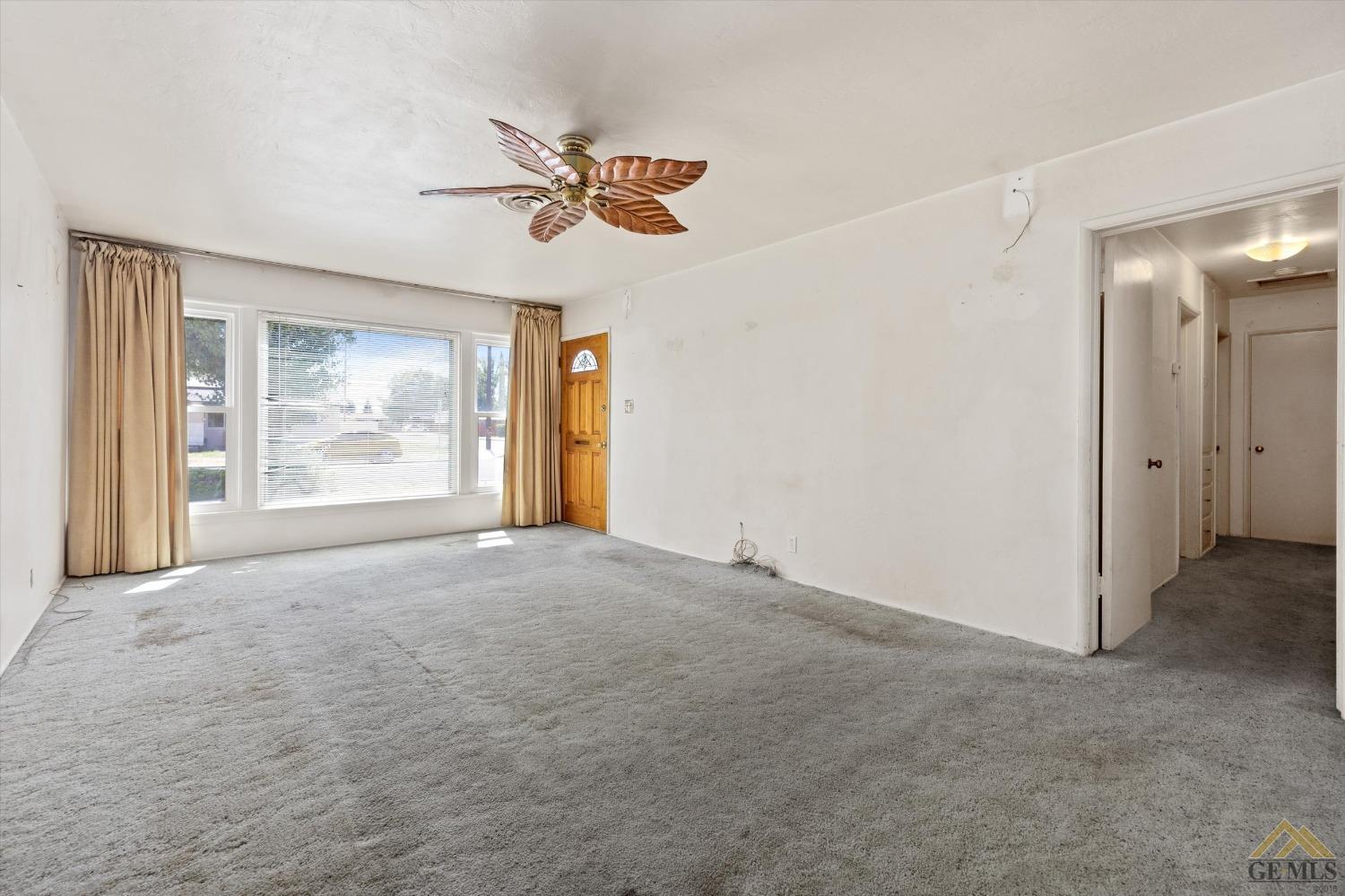 Undisclosed Address Wasco, CA 93280 - Photo 5 of 21 a view of an empty room with a window