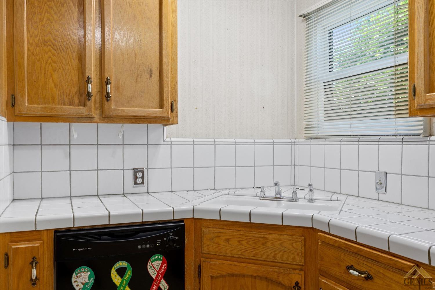 Undisclosed Address Wasco, CA 93280 - Photo 7 of 21 a kitchen with a sink and cabinets