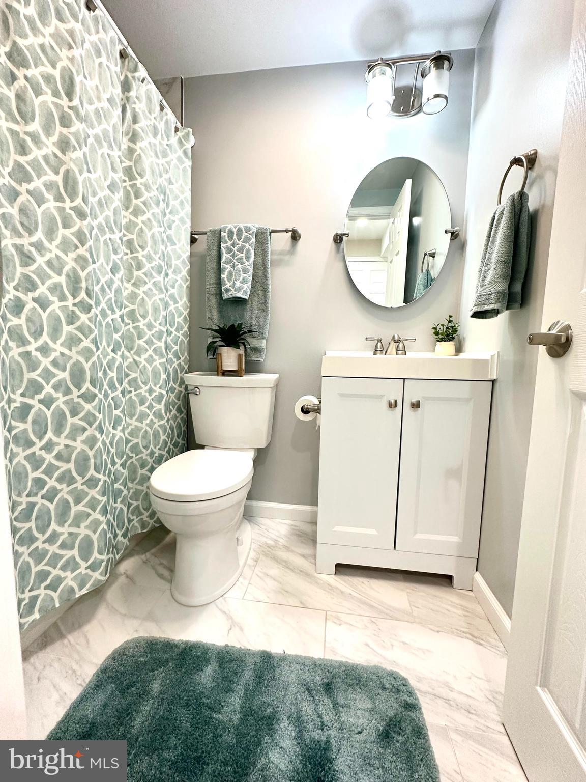 8301 Windfall Road Springfield, VA 22153 - Photo 9 of 22 a bathroom with a toilet sink and mirror