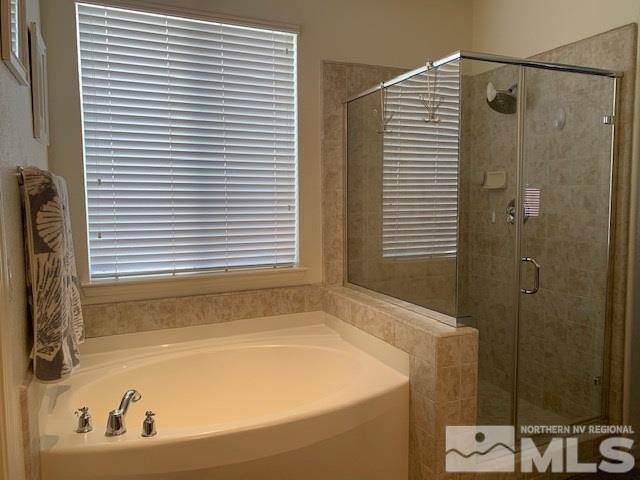 2581 Spring Flower Drive Reno, NV 89521 - Photo 11 of 14 a bathroom with a bathtub and a shower