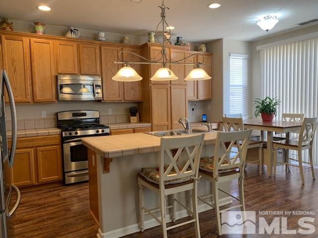 2581 Spring Flower Drive Reno, NV 89521 - Photo 2 of 14 a kitchen with a table chairs stove and cabinets