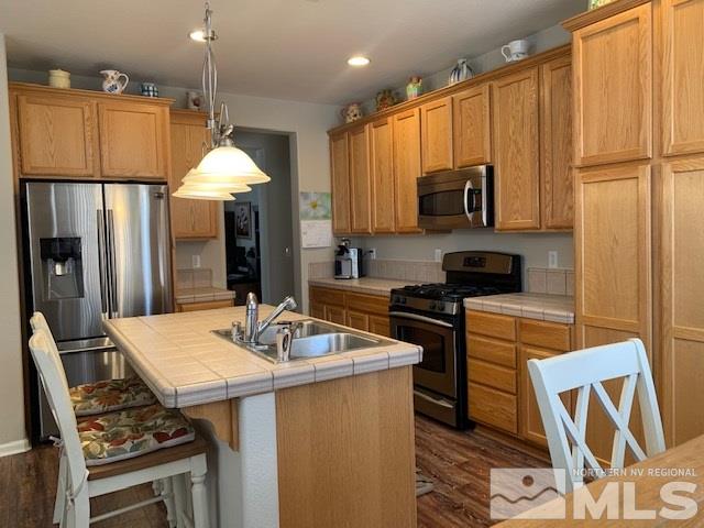 2581 Spring Flower Drive Reno, NV 89521 - Photo 3 of 14 a kitchen with a stove a sink and a refrigerator