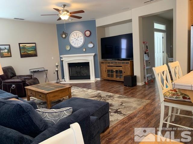 2581 Spring Flower Drive Reno, NV 89521 - Photo 6 of 14 a living room with furniture a flat screen tv and a fireplace