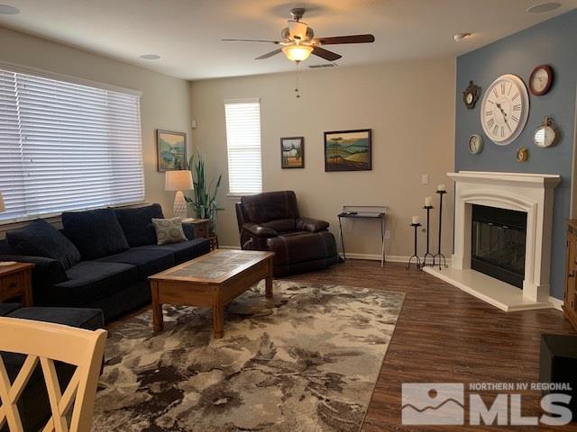 2581 Spring Flower Drive Reno, NV 89521 - Photo 7 of 14 a living room with furniture a fireplace and a window