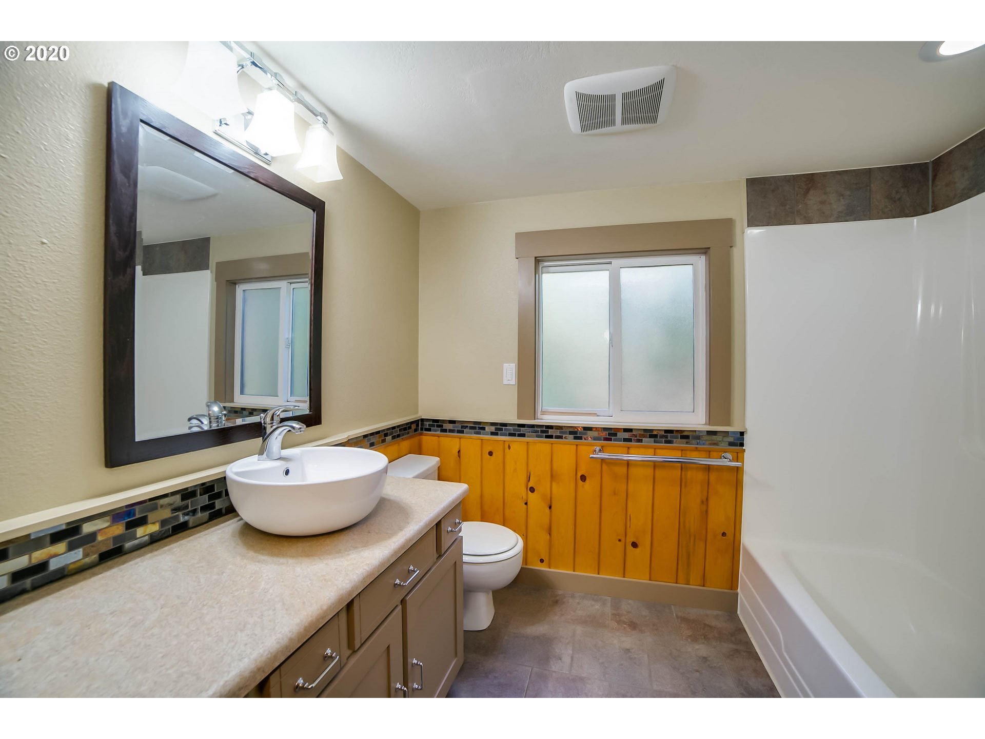 65279 East Timberline Drive Rhododendron, OR 97049 - Photo 16 of 32 a bathroom with a granite countertop sink mirror vanity and toilet