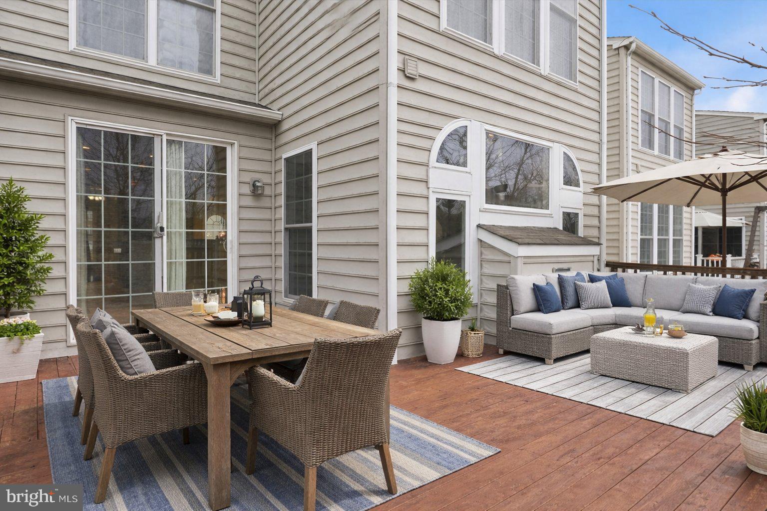 42906 Bittner Square Ashburn, VA 20148 - Photo 11 of 31 a view of a patio with couches table and chairs and potted plants