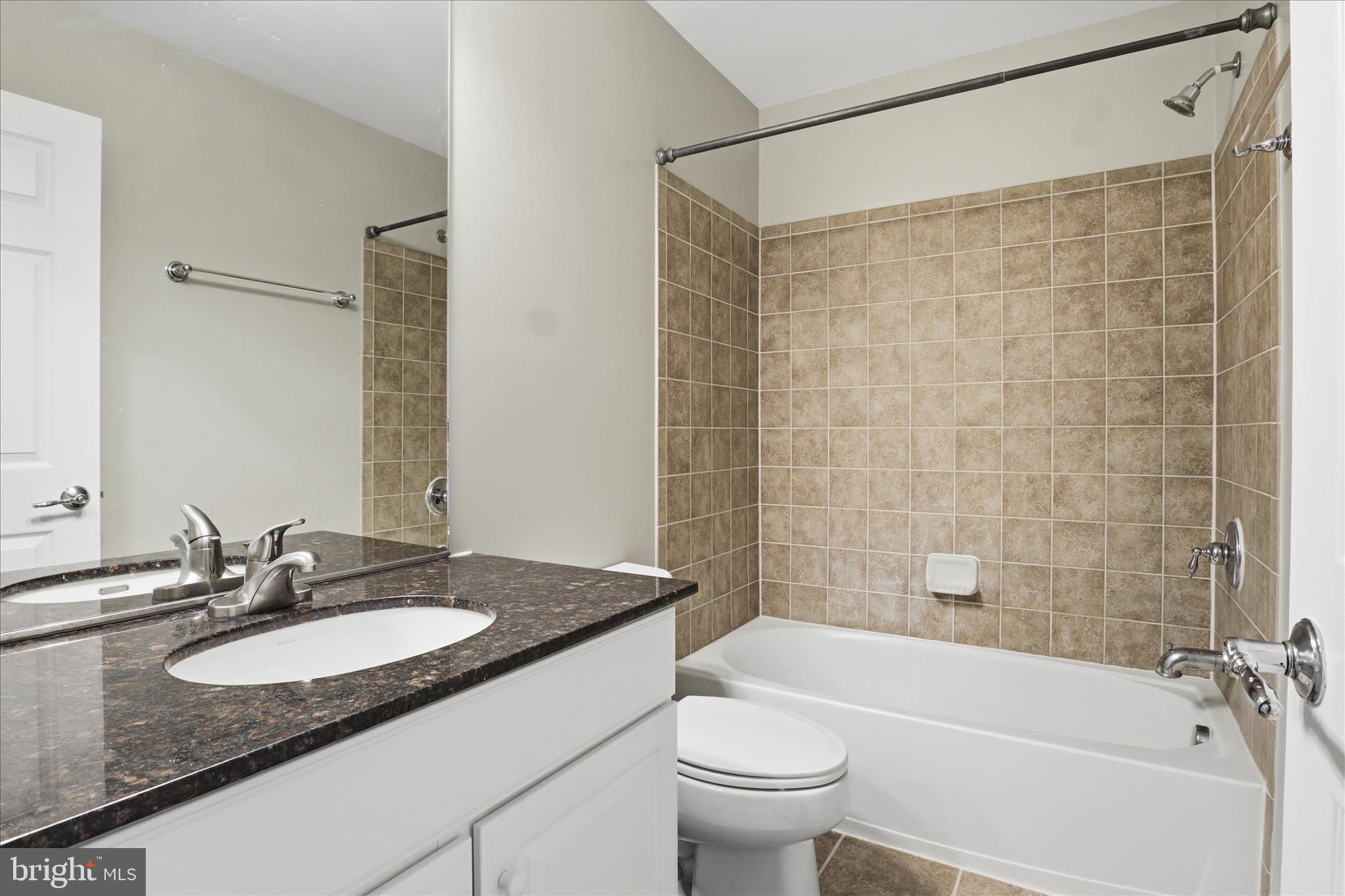 42906 Bittner Square Ashburn, VA 20148 - Photo 16 of 31 a bathroom with a granite countertop sink toilet and shower