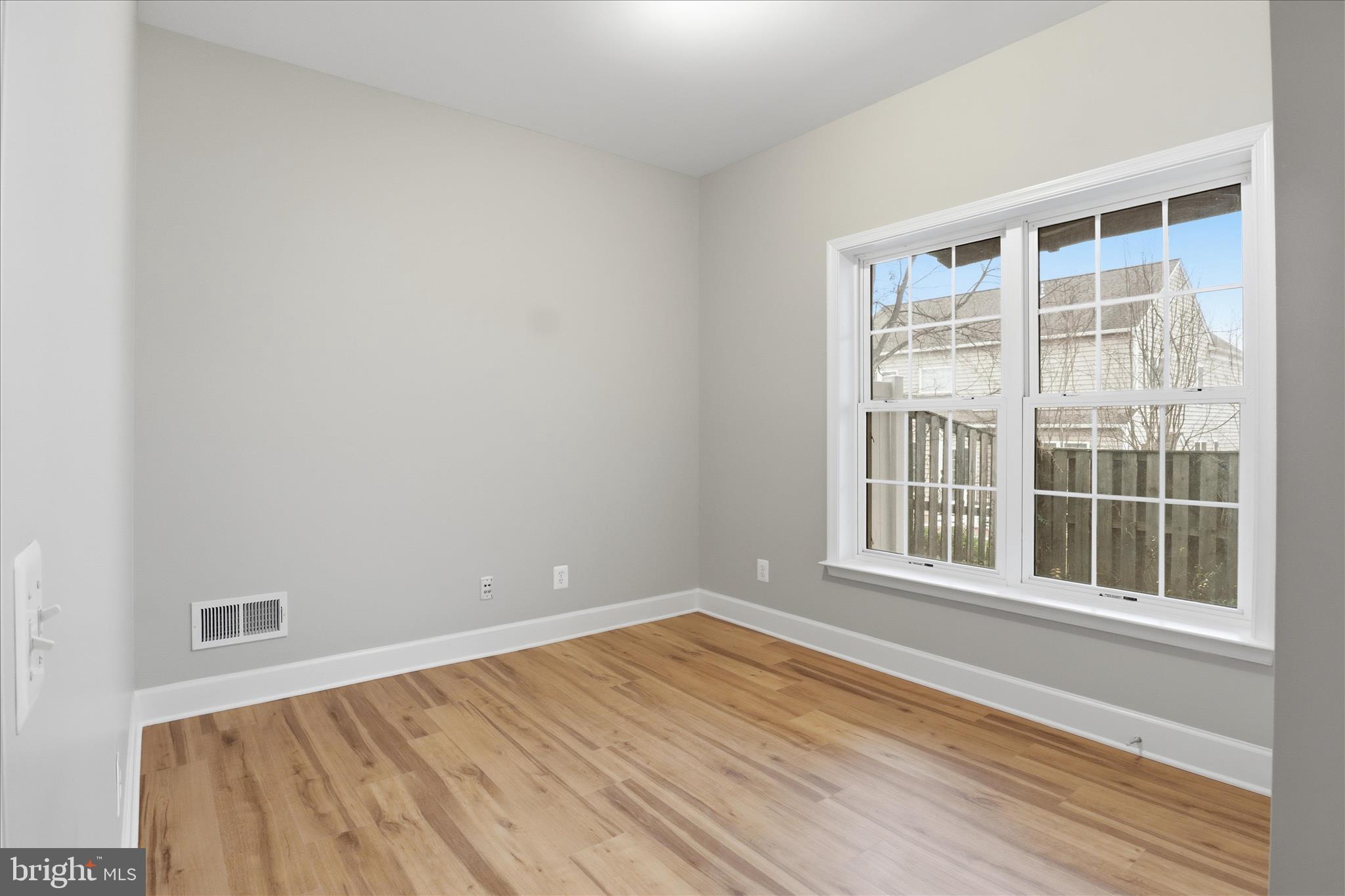 42906 Bittner Square Ashburn, VA 20148 - Photo 22 of 31 an empty room with wooden floor and windows
