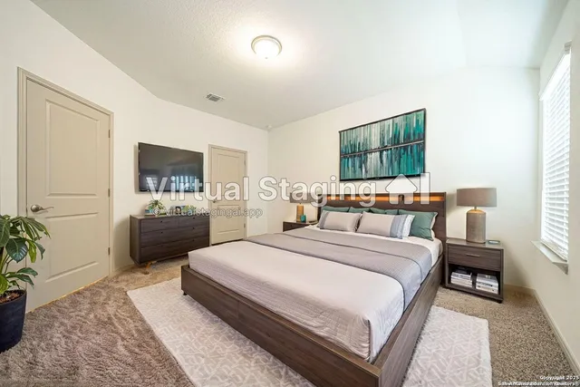 a bedroom with a bed and a flat screen tv