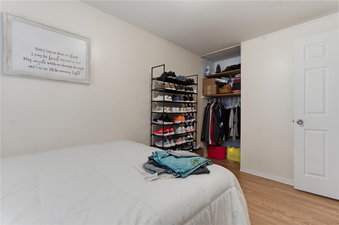 707 West Martindale Road Union, OH 45322 - Photo 13 of 28 This cozy bedroom features warm wooden flooring and a convenient open closet, offering both comfort and practical storage.
