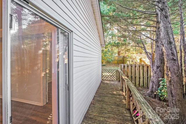a view of balcony with wooden floor and fence