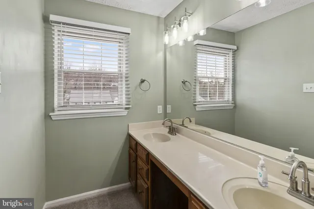a bathroom with a sink a vanity and a mirror