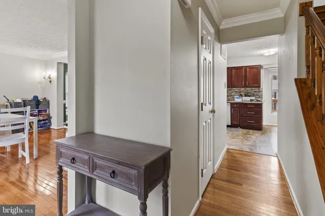 a view of a hallway and a livingroom with furniture