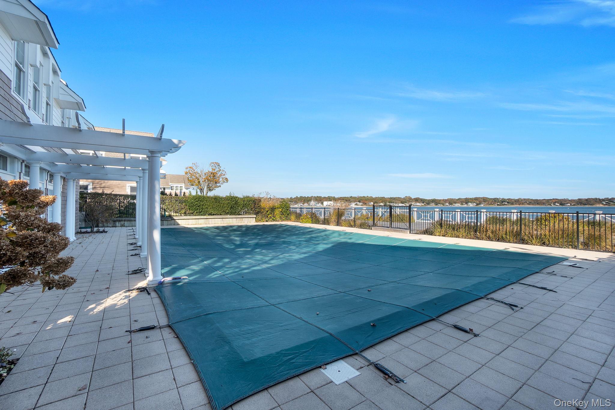 62 Canoe Place Road, Unit 513/5 Hampton Bays, NY 11946 - Photo 12 of 15 View of pool with a pergola, a water view, and a patio area