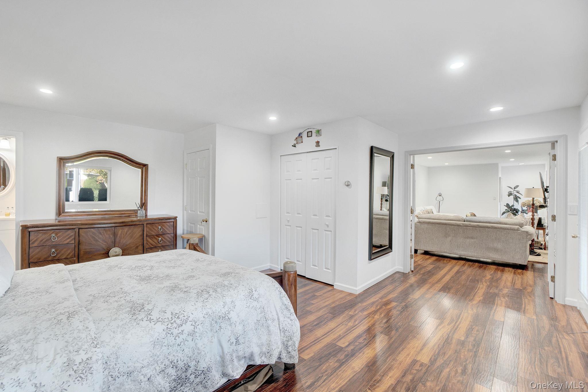 62 Canoe Place Road, Unit 513/5 Hampton Bays, NY 11946 - Photo 6 of 15 Bedroom with dark wood-style floors, recessed lighting, and a closet