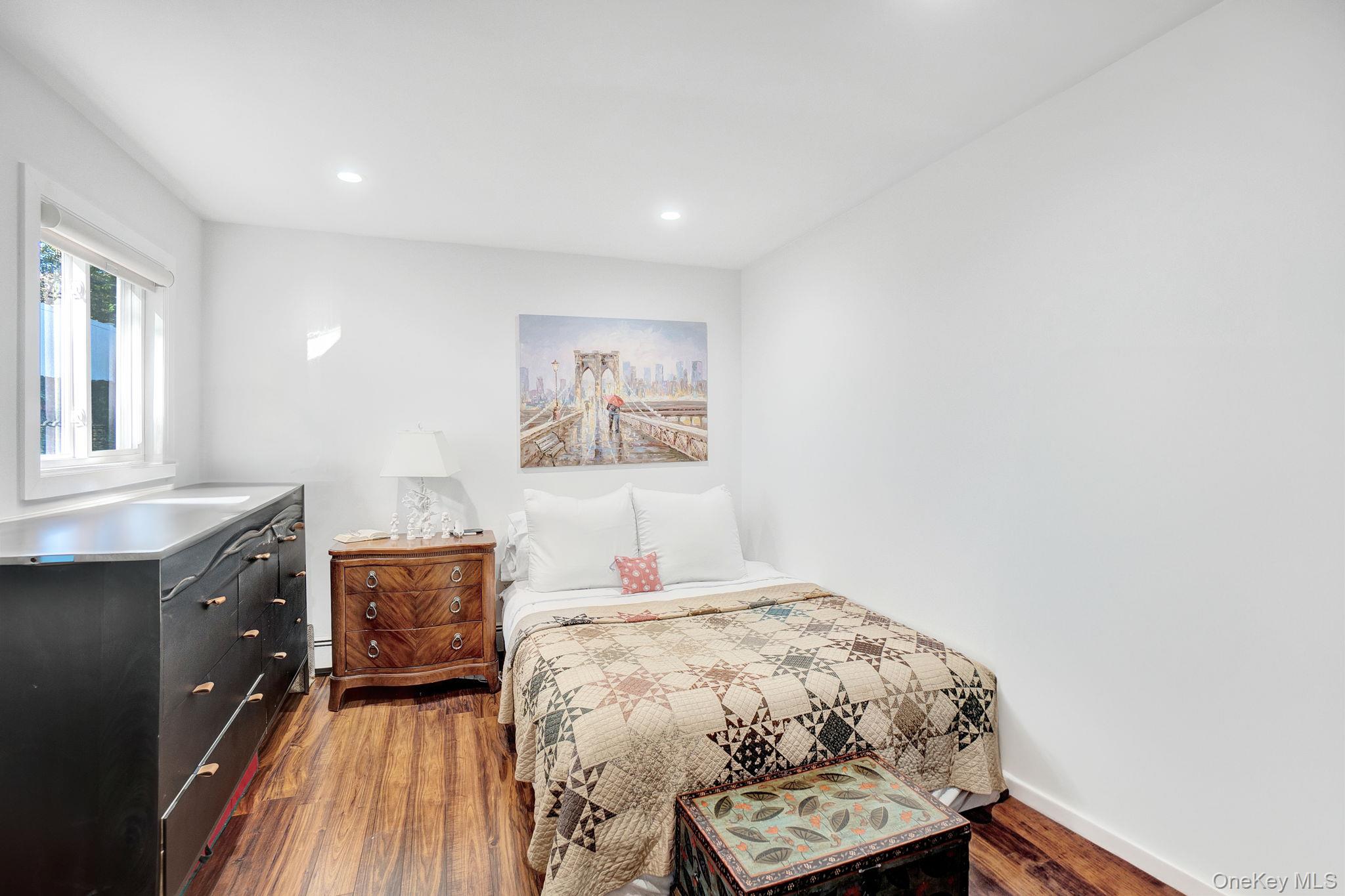 62 Canoe Place Road, Unit 513/5 Hampton Bays, NY 11946 - Photo 9 of 15 Bedroom featuring dark wood-style flooring and recessed lighting