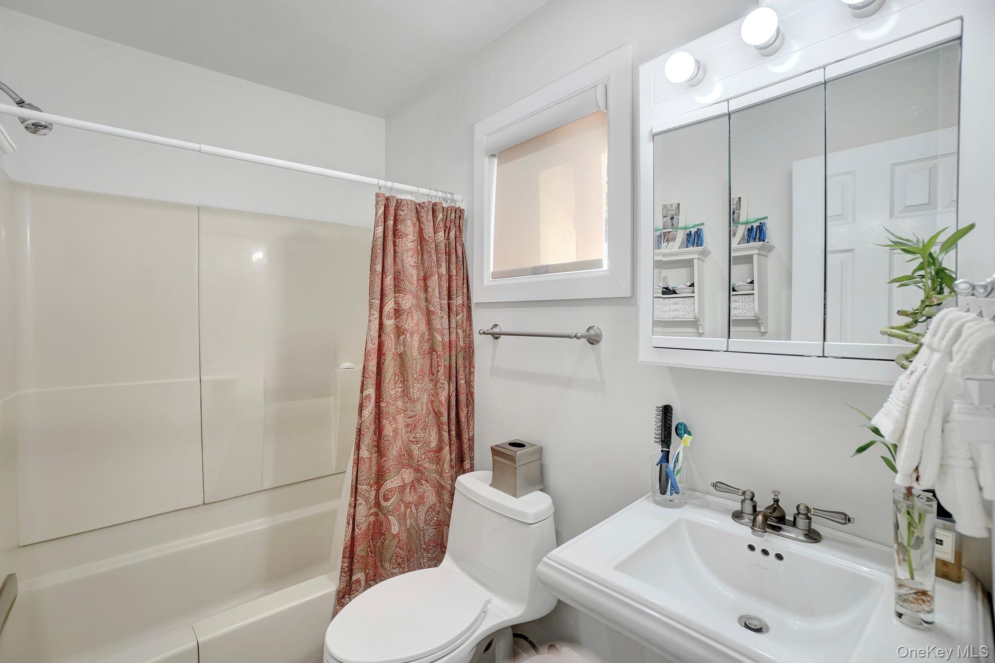 62 Canoe Place Road, Unit 513/5 Hampton Bays, NY 11946 - Photo 10 of 15 Full bathroom with shower / tub combo and toilet
