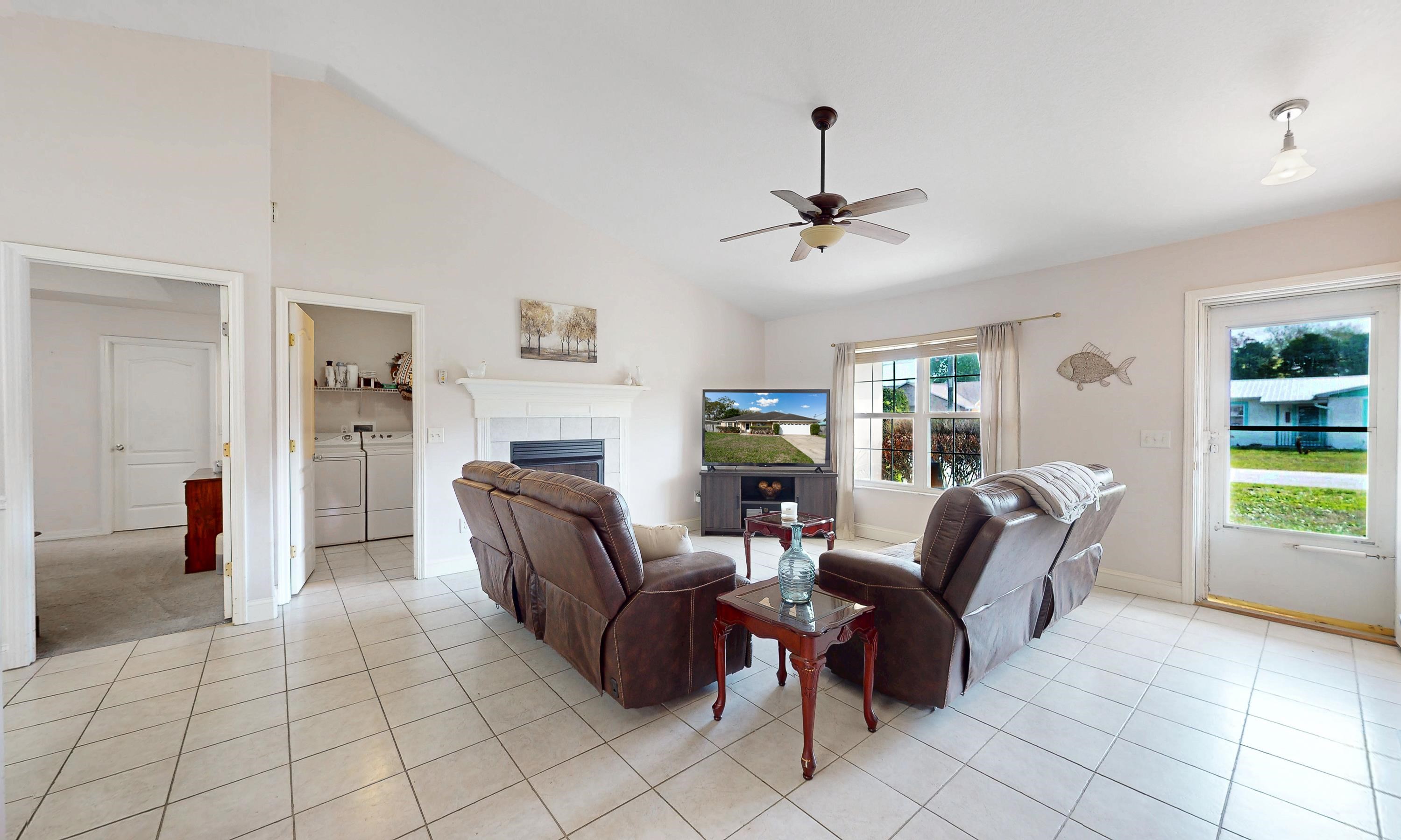 330 Segovia Road St. Augustine, FL 32086 - Photo 6 of 52 a living room with furniture a fireplace and a chandelier