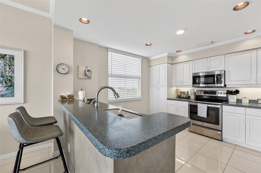2060 Matecumbe Key Road, Unit 2506 Punta Gorda, FL 33955 - Photo 7 of 38 a kitchen with stainless steel appliances granite countertop a sink a stove and a refrigerator