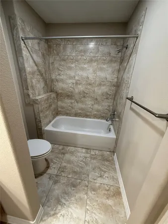 a bathroom with a bathtub and a toilet