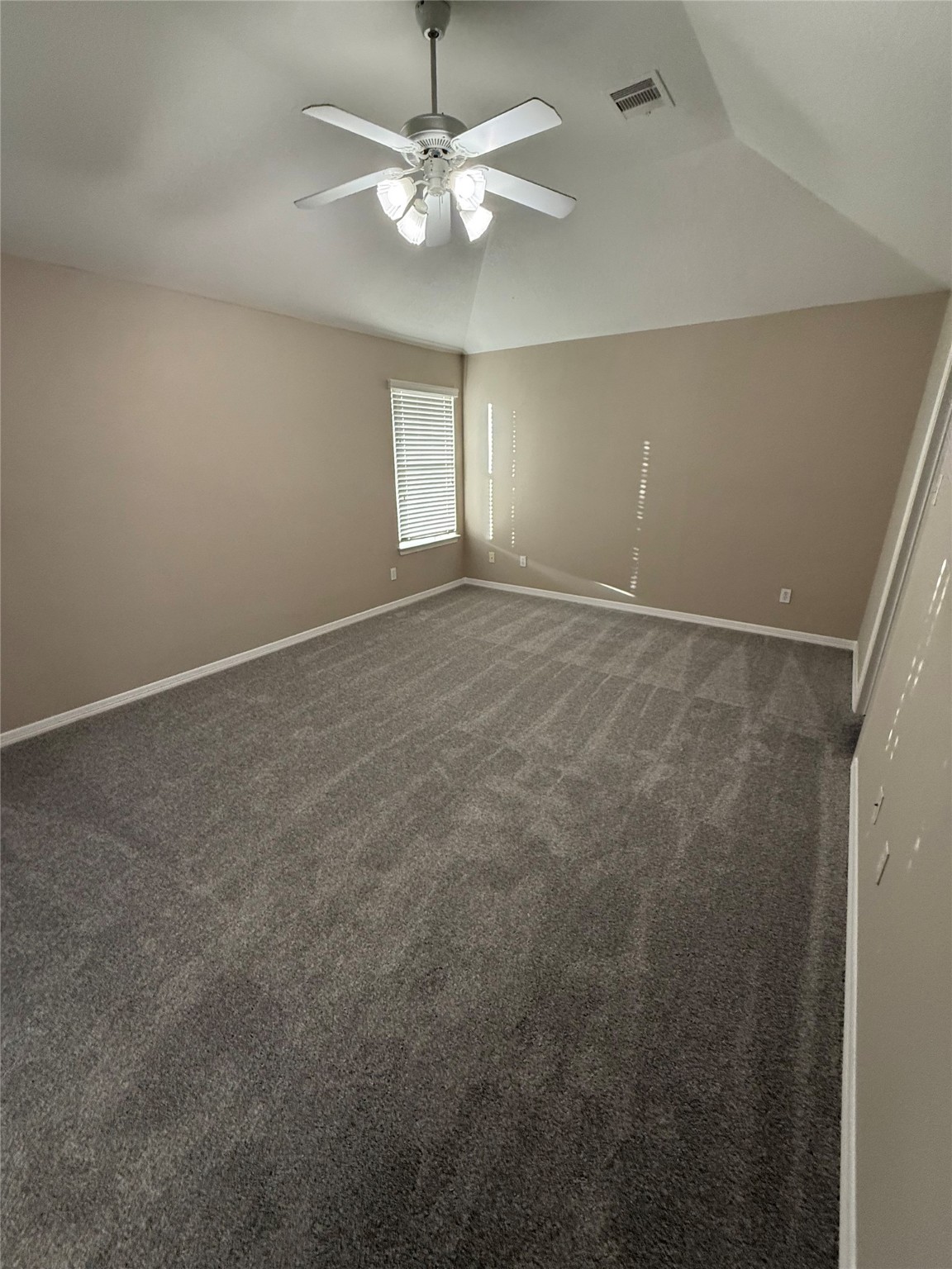 9224 Rodney Ray Boulevard, Unit 1 Houston, TX 77040 - Photo 8 of 11 en empty room with windows and ceiling fan