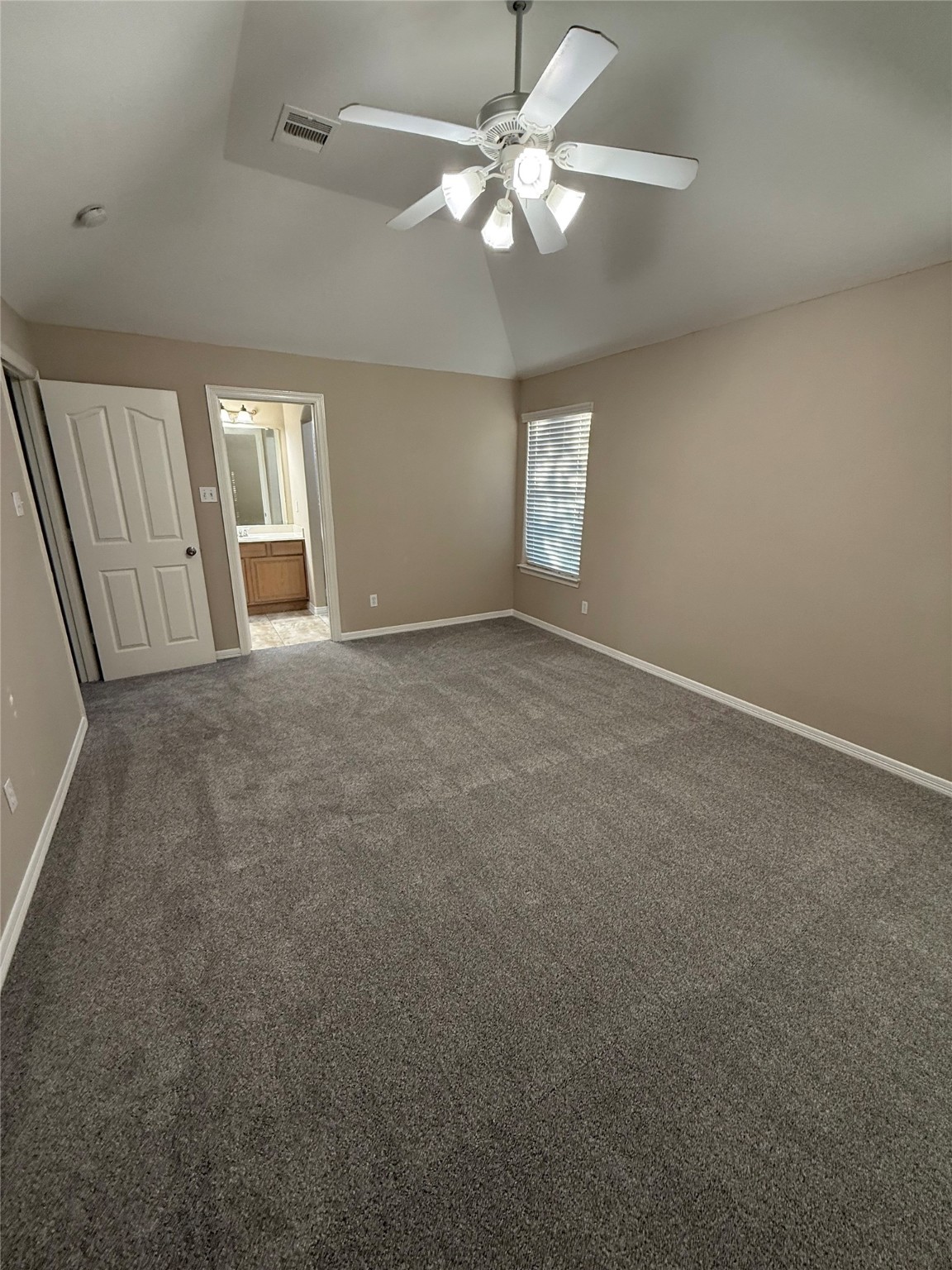 9224 Rodney Ray Boulevard, Unit 1 Houston, TX 77040 - Photo 9 of 11 an empty room with windows and fan