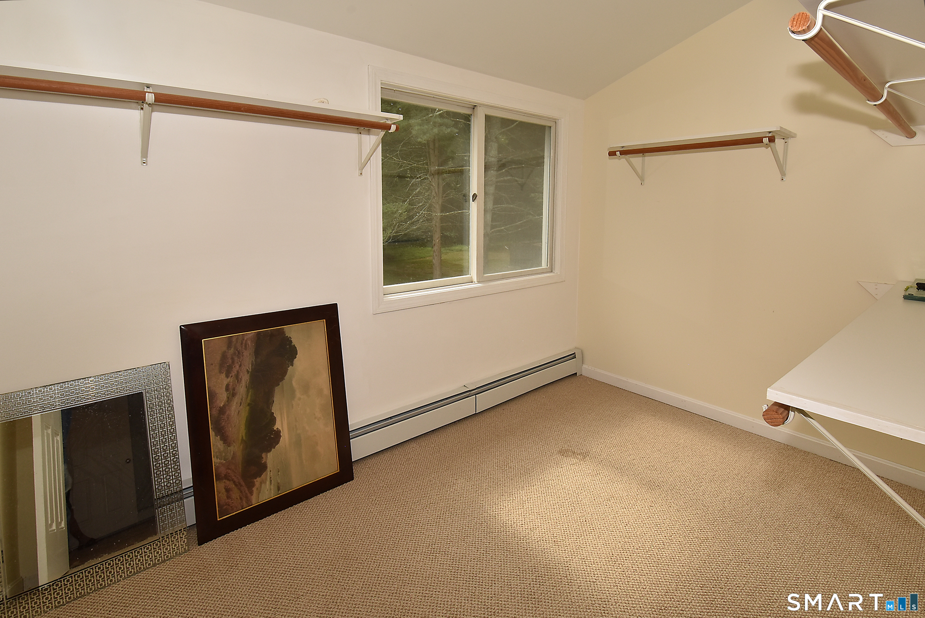 50 Doubleday Road Columbia, CT 06237 - Photo 24 of 29 This large walk-in closet offers extensive storage space and custom organization, keeping your wardrobe neatly tucked away in the primary suite.