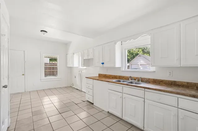 a kitchen with a sink cabinets and window