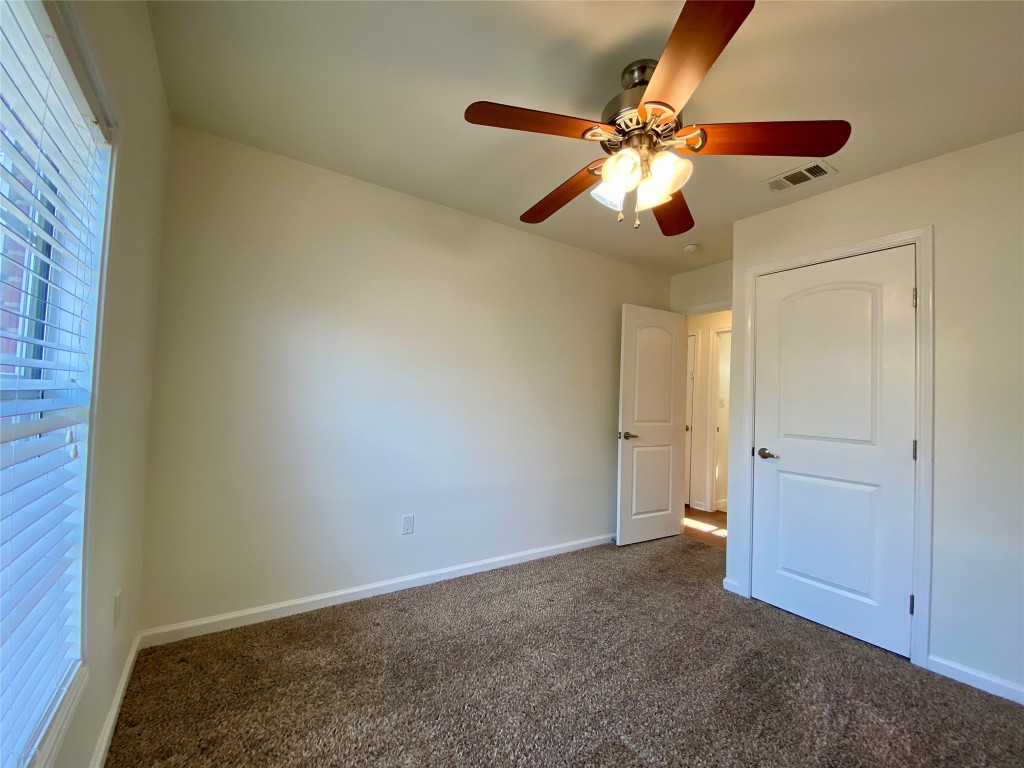 2003 Patton Lane Austin, TX 78723 - Photo 22 of 38 Guest Bedroom 1 with dark colored carpet and ceiling fan