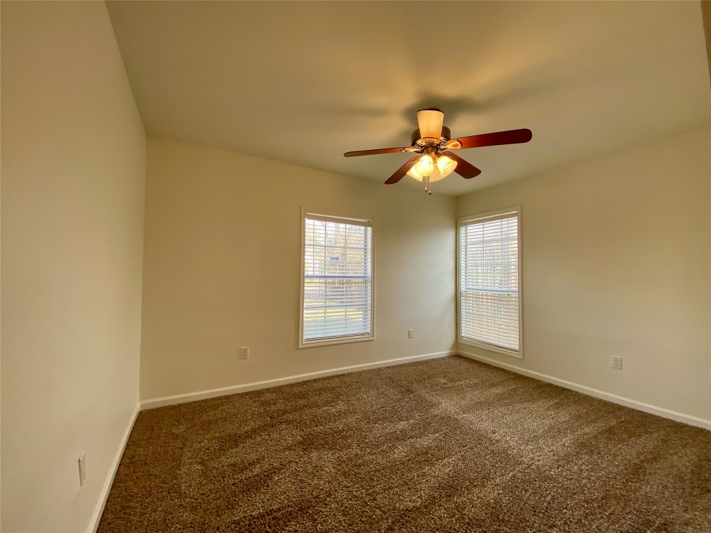 2003 Patton Lane Austin, TX 78723 - Photo 23 of 38 Guest Bedroom 2 with dark carpet and ceiling fan