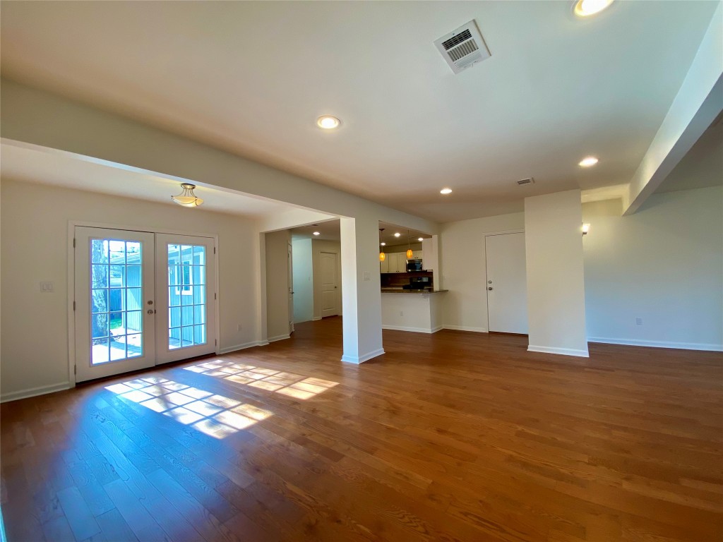 2003 Patton Lane Austin, TX 78723 - Photo 6 of 38 Living room with french doors, recessed lighting, and light wood floors
