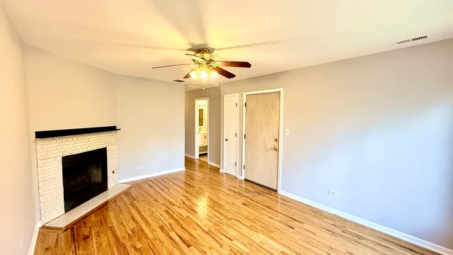 a bedroom with a bed and a ceiling fan