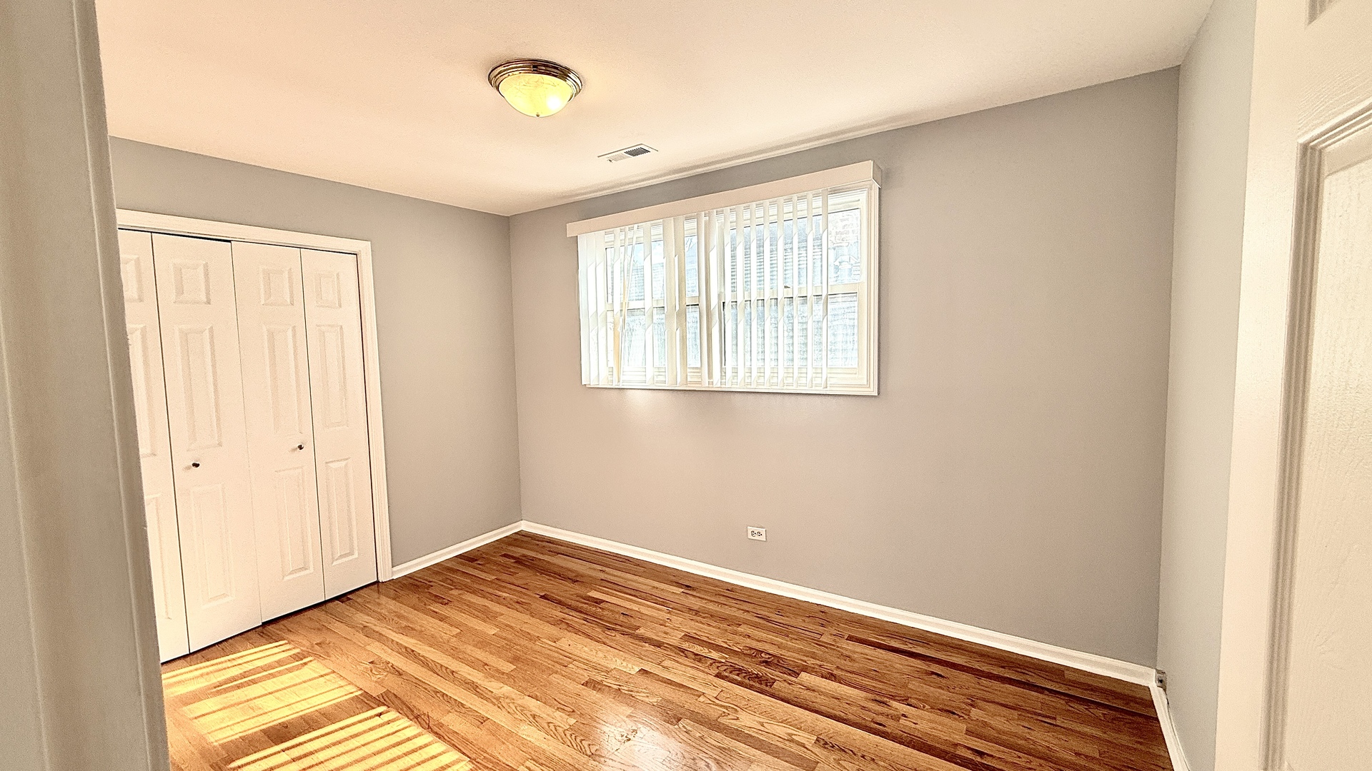 1078 North Hermitage Avenue, Unit 3 Chicago, IL 60622 - Photo 5 of 17 a view of a room with wooden floor and windows