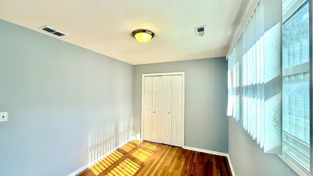 a view of a livingroom with wooden floor and a window