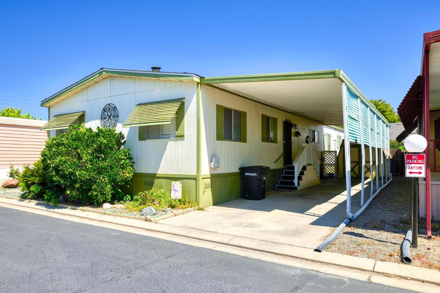 1200 South Carpenter Road, Unit 4 Modesto, CA 95351 - Photo 1 of 31 White and green paneled exterior with a covered carport