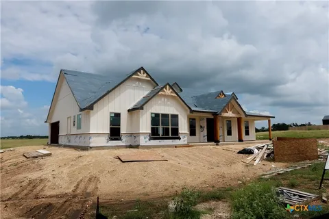 a view of a house with a yard covered in snow