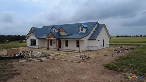 a view of a house with a wooden fence
