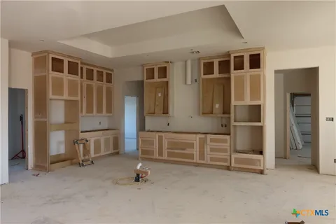 a view of living room kitchen and entryway