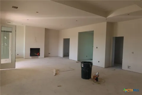 an empty room with fireplace and closet