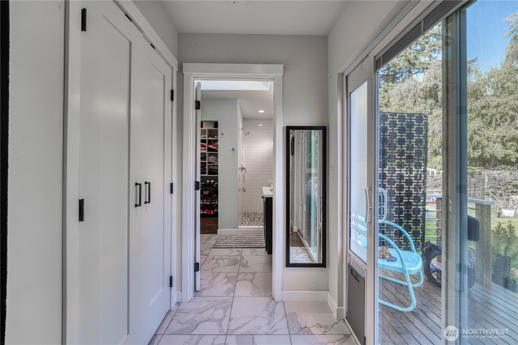 10536 Northeast 189th Street Bothell, WA 98011 - Photo 15 of 37 a view of a hallway with wooden floor and a bathroom