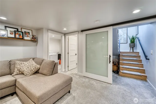 a living room with furniture and a ceiling fan