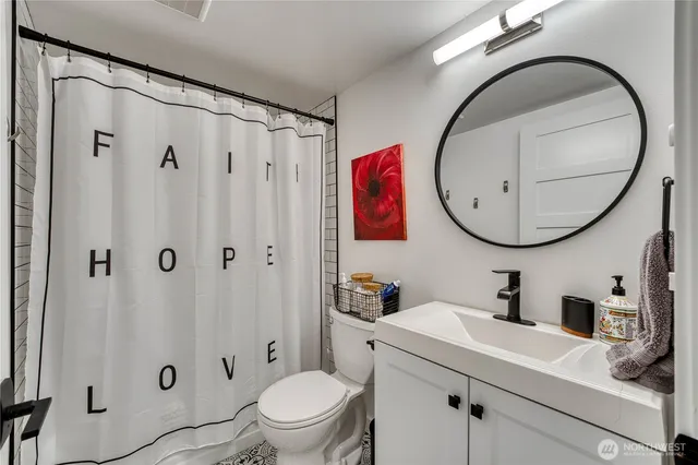 a bathroom with a sink a mirror a toilet and a mirror